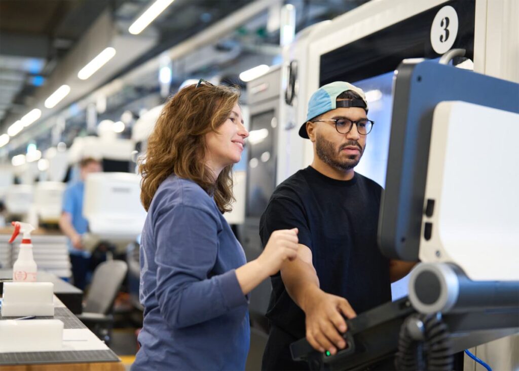 Apple factory, man and woman looking at screen