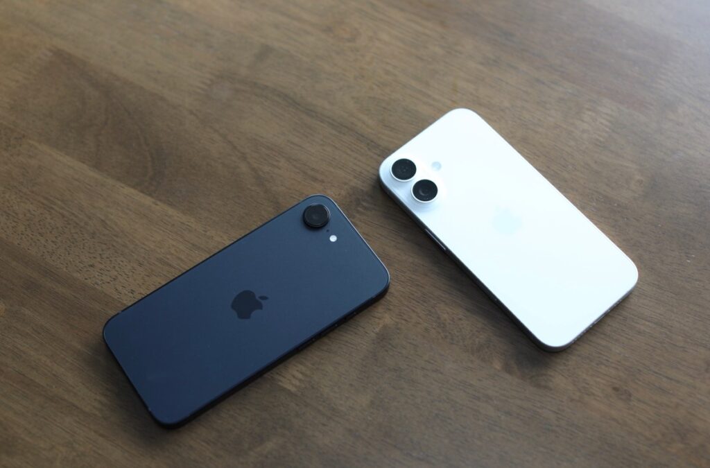 Two Apple iPhone 16e units splayed on table