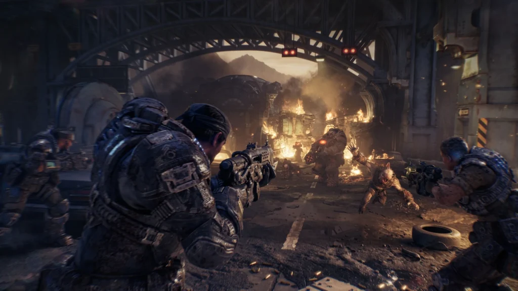 Soldiers in heavy armor fighting monsters in a destroyed industrial environment from Gears of War: E-Day.