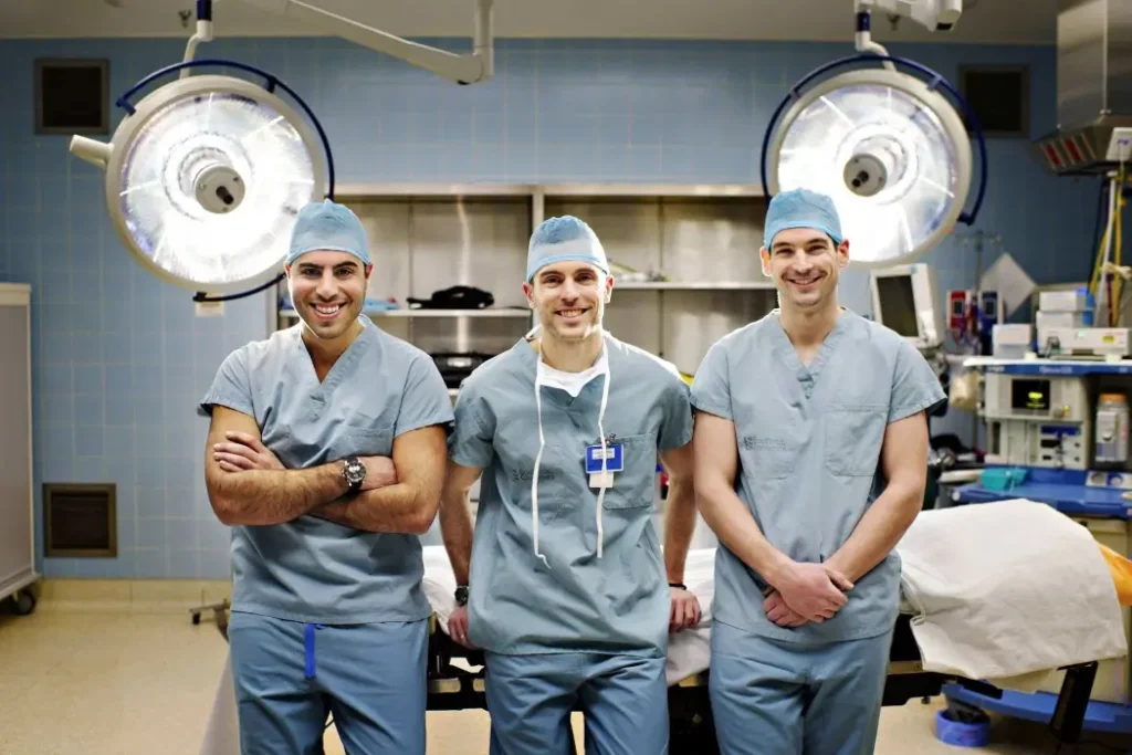 Intellijoint Surgical wants to prove Canadian medtech companies can grow on their own terms The Intellijoint Founders stand together in a surgicla room, wearing scrubs.
